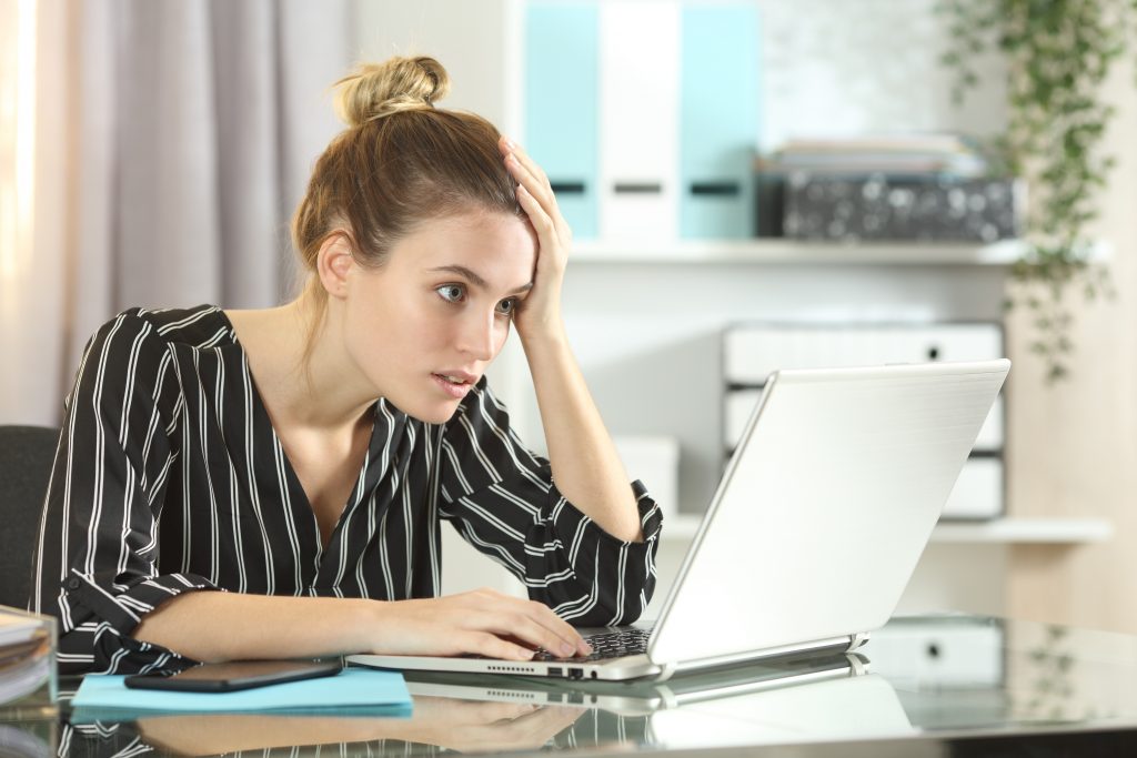 worried businesswoman discovering lost work on laptop. Data backup solutions in Devon
