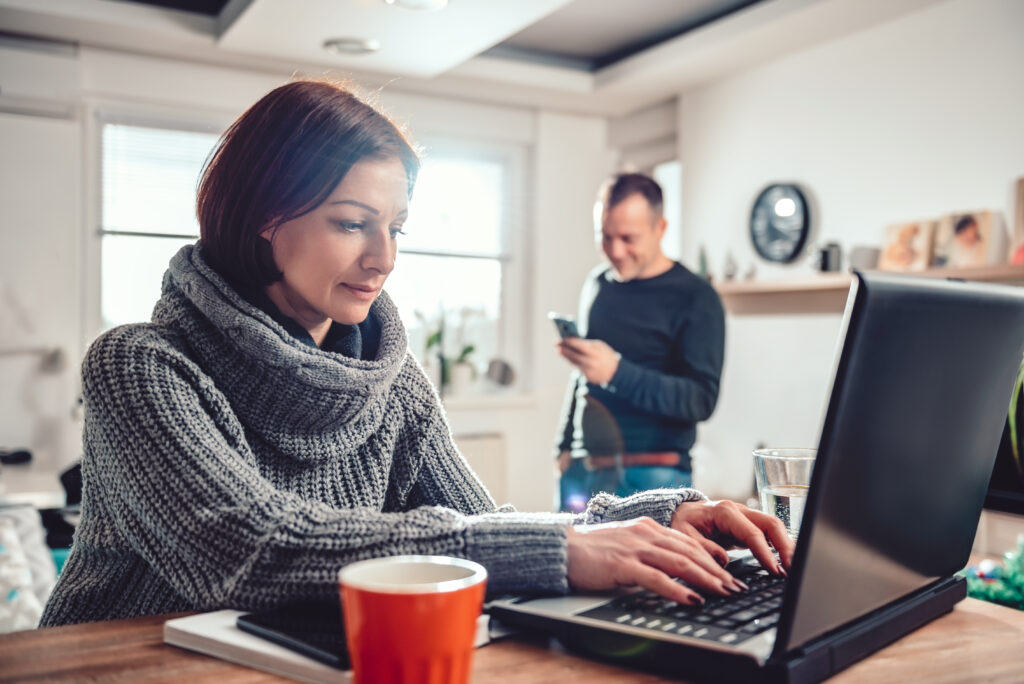 Woman using laptop in home office. Homeworking. Remote Working.