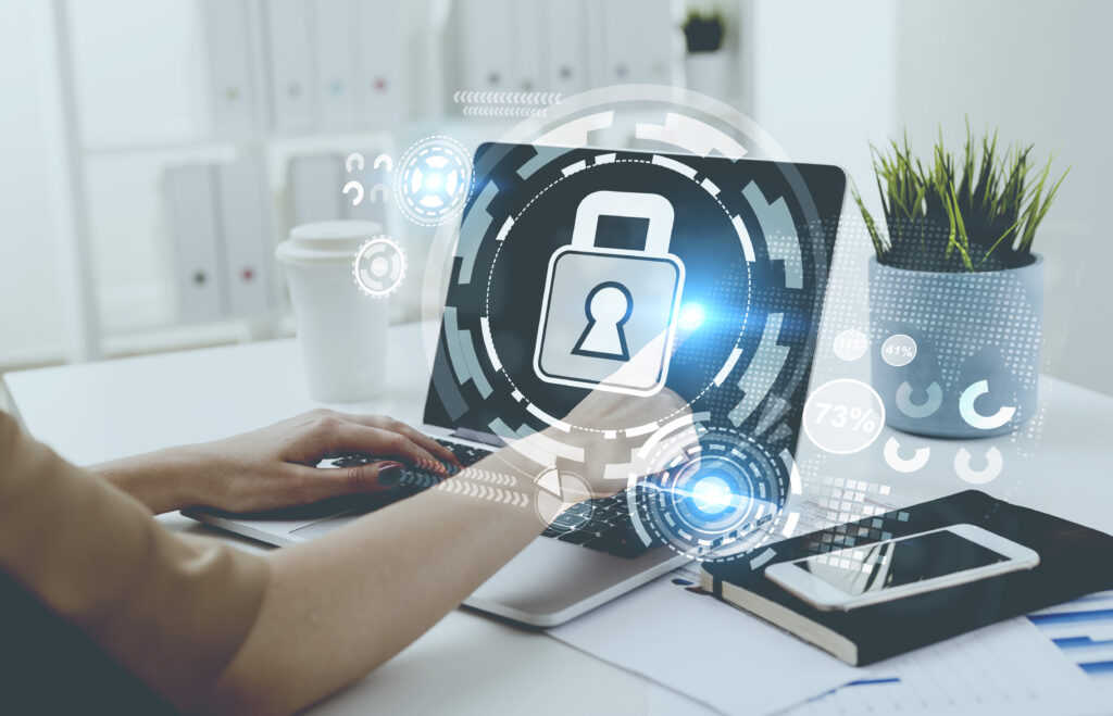 Image depicting digital security. Businesswomen typing at her laptop.